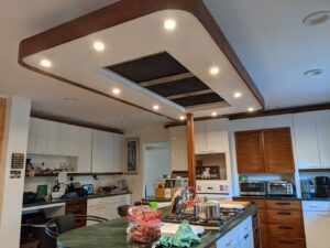 A modern kitchen featuring recessed lighting and a range hood, showcasing electrical installations by Primo's Electrical Services in San Diego, CA.