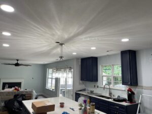 A kitchen with newly installed recessed lights and a chandelier, showcasing electrical work by Denny Power Solutions in Virginia Beach, VA