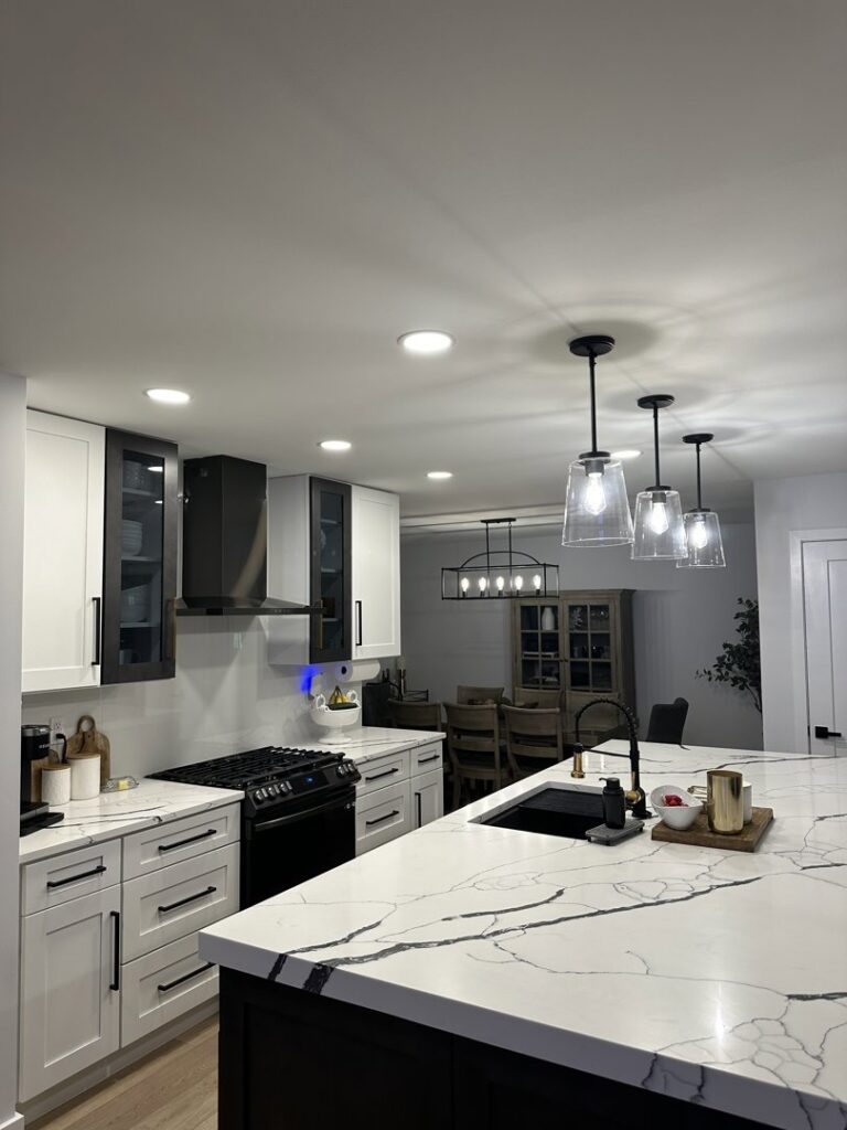 A modern kitchen featuring newly installed recessed and pendant lighting by E & E Electric in Post Falls, ID.
