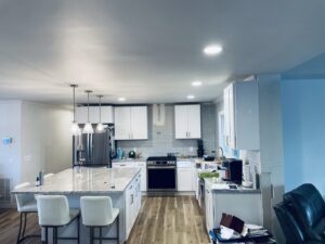 A modern kitchen featuring new recessed and pendant lighting installed by Royal Electric Services in Raleigh, NC