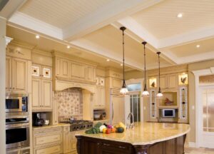 Modern kitchen with recessed ceiling lights and pendant lighting over the island by T.S.F Electric in Saco, ME.