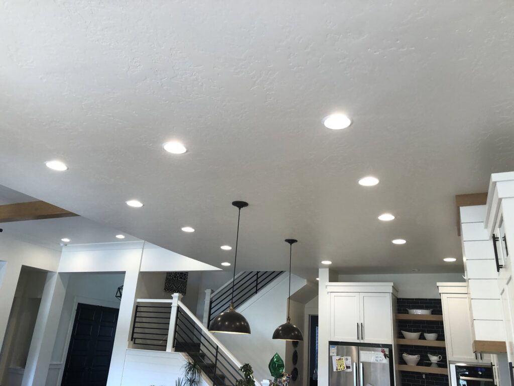 Bright kitchen and living area with new recessed and pendant lighting installed by Veritas Electric in Yalaha, FL.