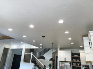 Bright kitchen and living area with new recessed and pendant lighting installed by Veritas Electric in Yalaha, FL.