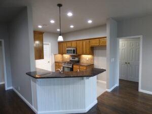 A modern kitchen featuring recessed and pendant lighting installed by Warner Electric Service, LLC in Broken Arrow, OK.