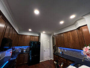 Kitchen with new recessed and blue under-cabinet lighting installed by Royal Electric Services in Raleigh, NC