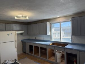 A kitchen undergoing remodel with new light fixtures and electrical outlets installed by Warren Electric in Oklahoma City, OK.