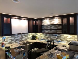 Modern kitchen with newly installed under-cabinet and accent lighting by Bacon Electric, LLC in Concord, NH.