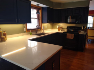 Bright under-cabinet lighting installed in a modern kitchen by Handy Hollms in Waukesha, WI