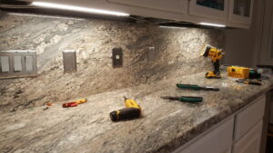 Kitchen countertop with new under-cabinet lighting and electrical outlets installed by Peace Of Mind Services in Sag Harbor, NY