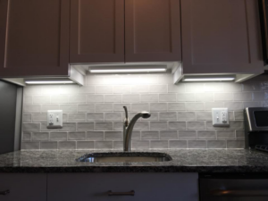 Bright under-cabinet lighting and electrical outlets in a modern kitchen, installed by ELSI Electric LLC in Rockville, MD.