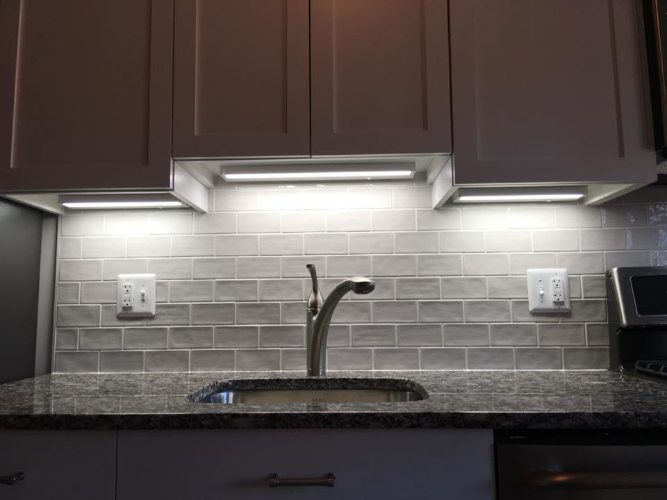 Bright under-cabinet lighting and electrical outlets in a modern kitchen, installed by ELSI Electric LLC in Rockville, MD.