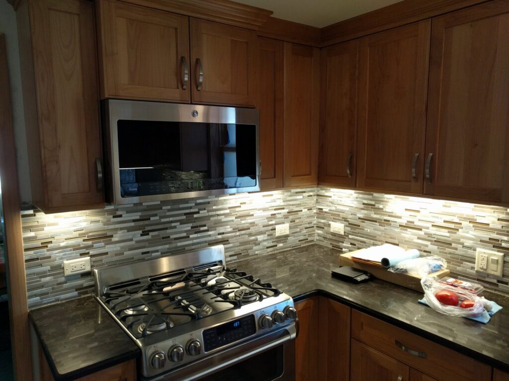 Kitchen corner with new under-cabinet lighting and electrical outlets installed by VIP Electrical Services in Naperville, IL.