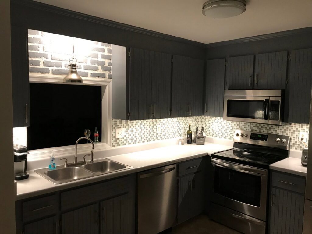 Modern kitchen with new under-cabinet lighting, pendant light, and recessed lights installed by C. C. Taylor Electric LLC in Powhatan, VA.
