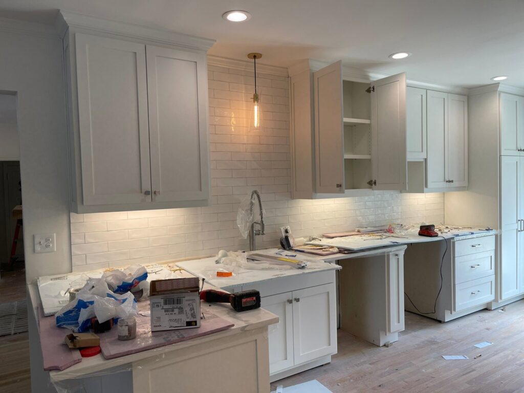 Newly installed under-cabinet lighting, pendant, and recessed lights in a kitchen by J&M Electrical Services in Stockbridge, GA.