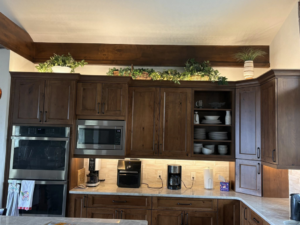 A modern kitchen featuring new under-cabinet and recessed lighting installed by JayCo Lighting & Electric in Colorado Springs, CO.