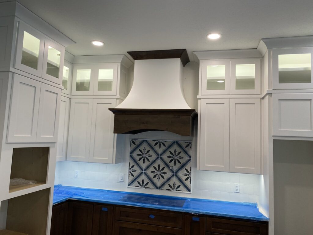 Modern kitchen featuring new under-cabinet lighting and recessed ceiling lights installed by Outlaw Home Services, LLC in San Antonio, Tx.