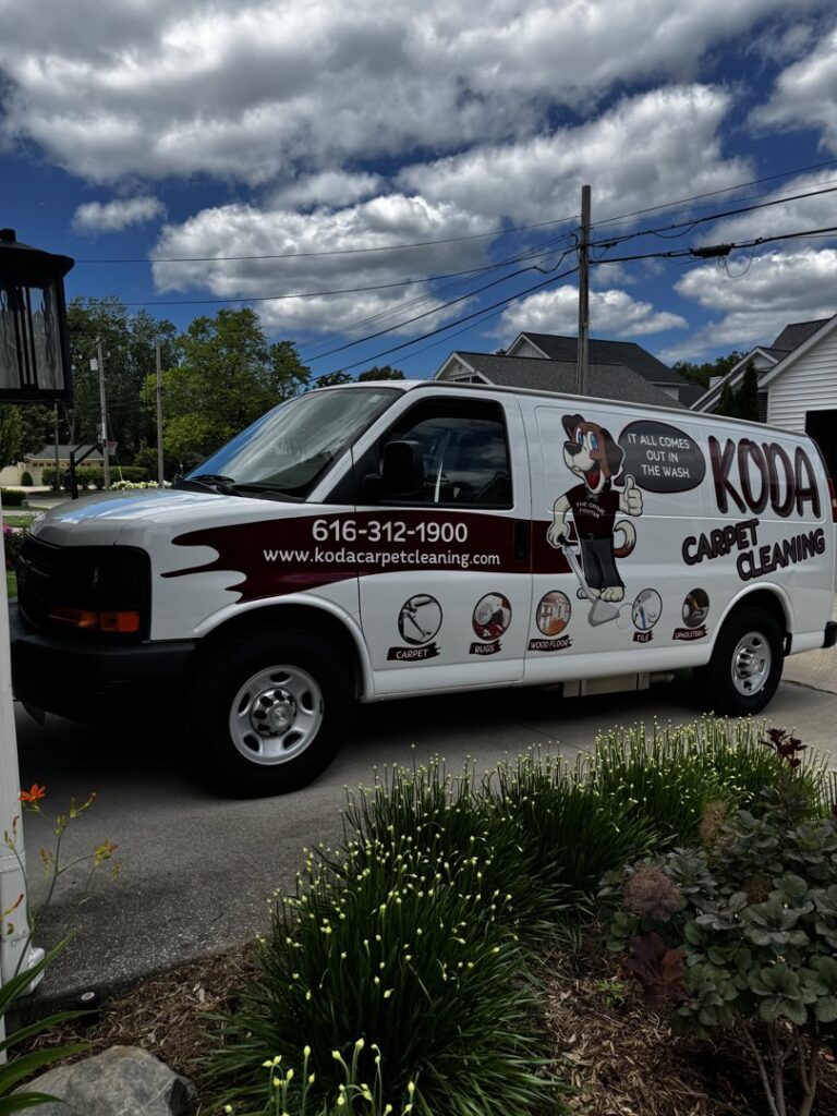 The KODA Carpet Cleaning branded service van parked at a residential job site in Holland, MI.