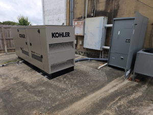 A Kohler generator and electrical panels installed outside a building by ECS. Electrical Contracting Services LLC in Lake Charles, LA.