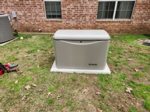 A Kohler standby generator installed on a concrete pad in a residential yard by GenTec Service and Repair in Bossier City, LA