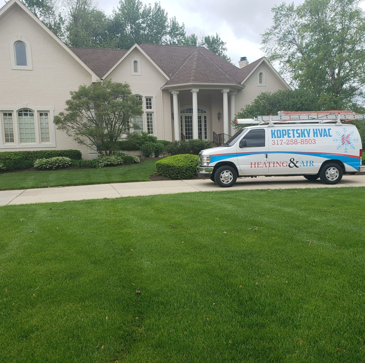 A Kopetsky HVAC service van parked in front of a residential home in Indianapolis, IN, ready for a job.