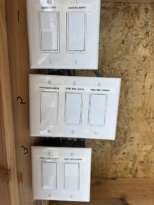 A clearly labeled light switch panel installation for various lights by Regal Electrical Services in West Jordan, UT.