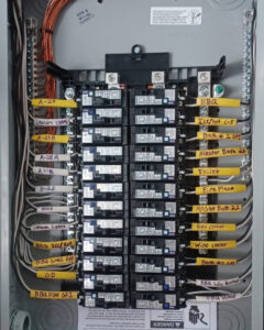 A neatly wired and labeled residential electrical panel with circuit breakers installed by Krakkom Electric in Sunrise, FL.