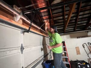 A ladder set up inside a garage, with a Garage Gecko service truck outside, indicating work in progress in Spokane, WA.