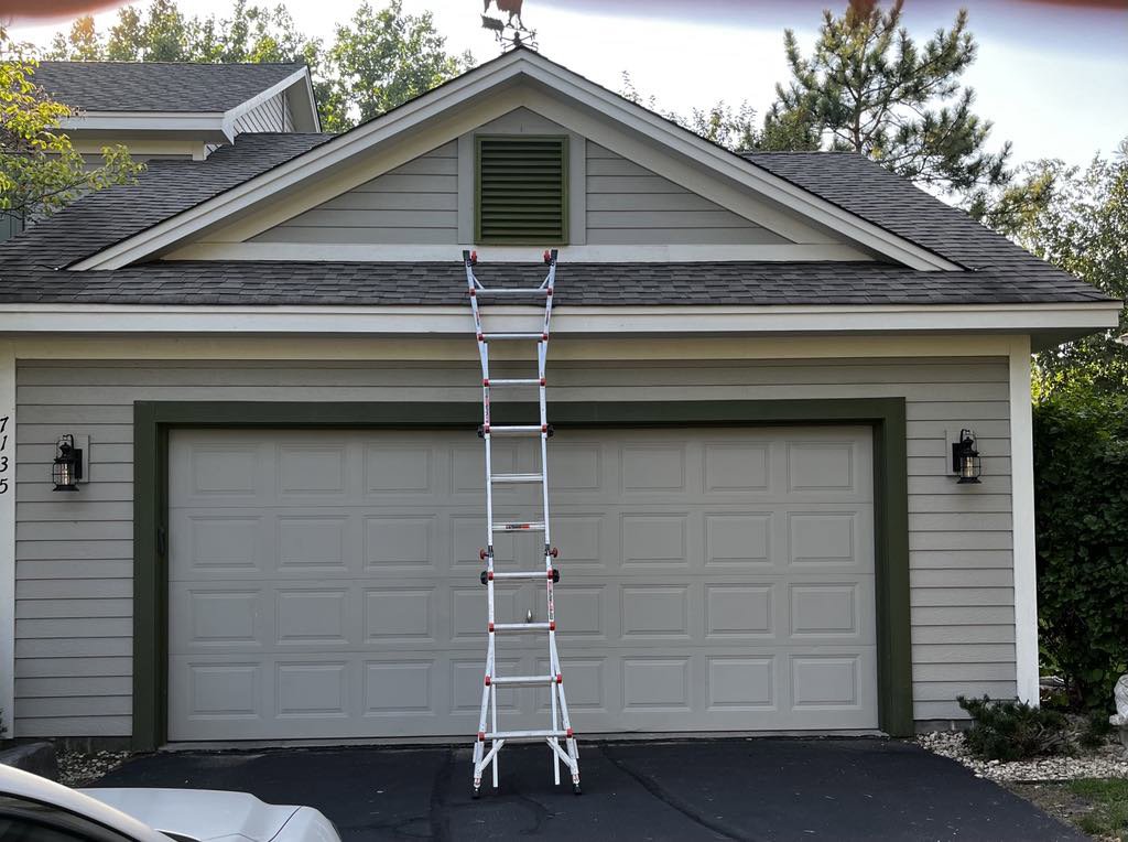 A ladder positioned for attic vent inspection or exclusion work on a residential garage by Stellar Wildlife Solutions in Cottage Grove, MN.