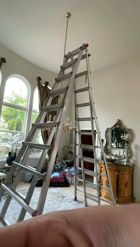 Ladders set up for light fixture installation or repair by Small Jobs Electric in Tampa, FL.