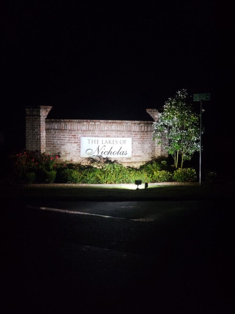 Landscape lighting illuminating a residential community sign by Superior Electric and Lighting LLC in Southaven, MS