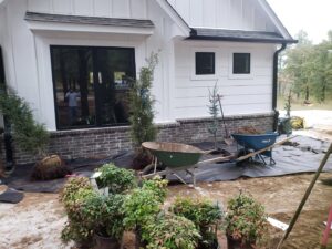 Landscaping and planting preparation with new plants and wheelbarrows by GAMAS Lawn Care Services in Tulsa, OK.