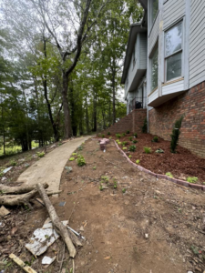 A landscaping project with new mulch and plants along a house by D&L lawn care service in Hoover, AL