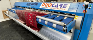 A large area rug being professionally cleaned by Duo-Care Cleaning and Restoration in Sterling Heights, MI
