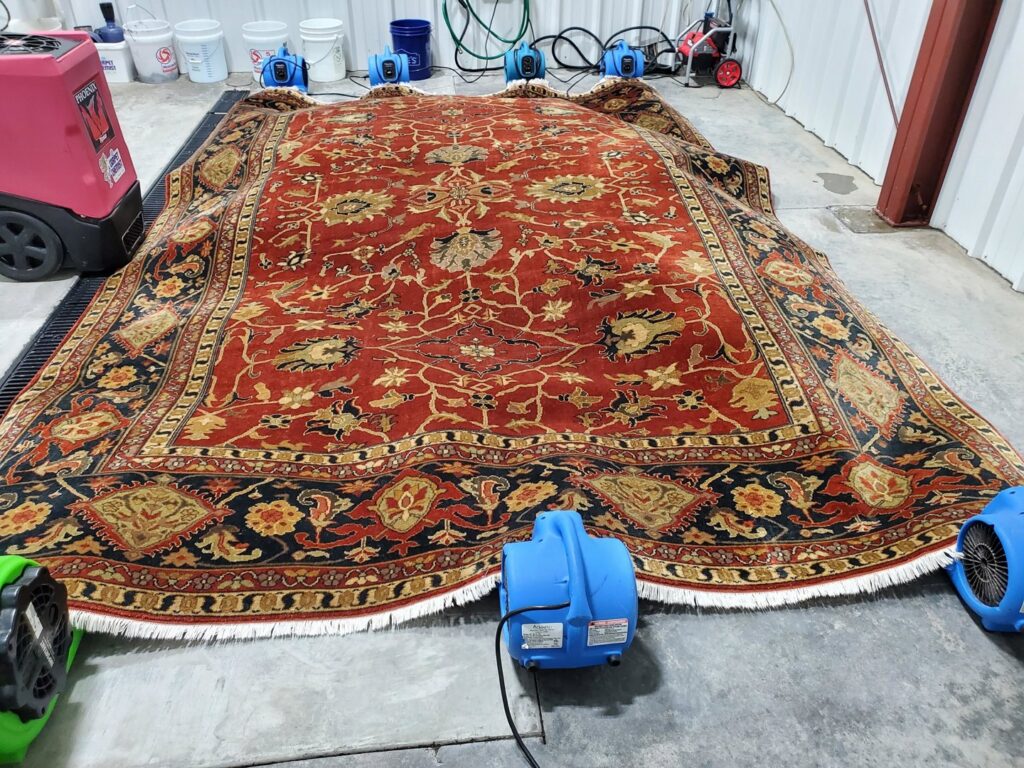 A large area rug being dried with professional air movers by The Carpet Chemist in Louisville, KY.