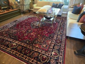A large, ornate area rug in a living room, ready for cleaning by Pure Steam Carpet Cleaning in Nashville, TN
