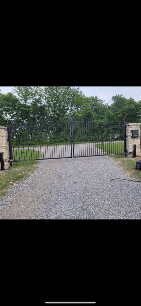 A large black wrought iron driveway gate installed by HDR Systems Gate, Fence & Garage doors in Plano, TX