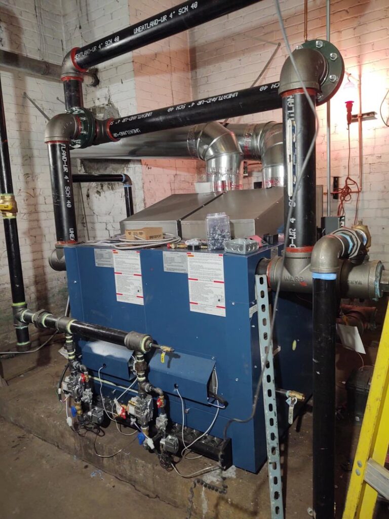 A large blue boiler unit with complex piping installed by Detroit Metro Mechanical, Inc. in Harrison Township, MI.