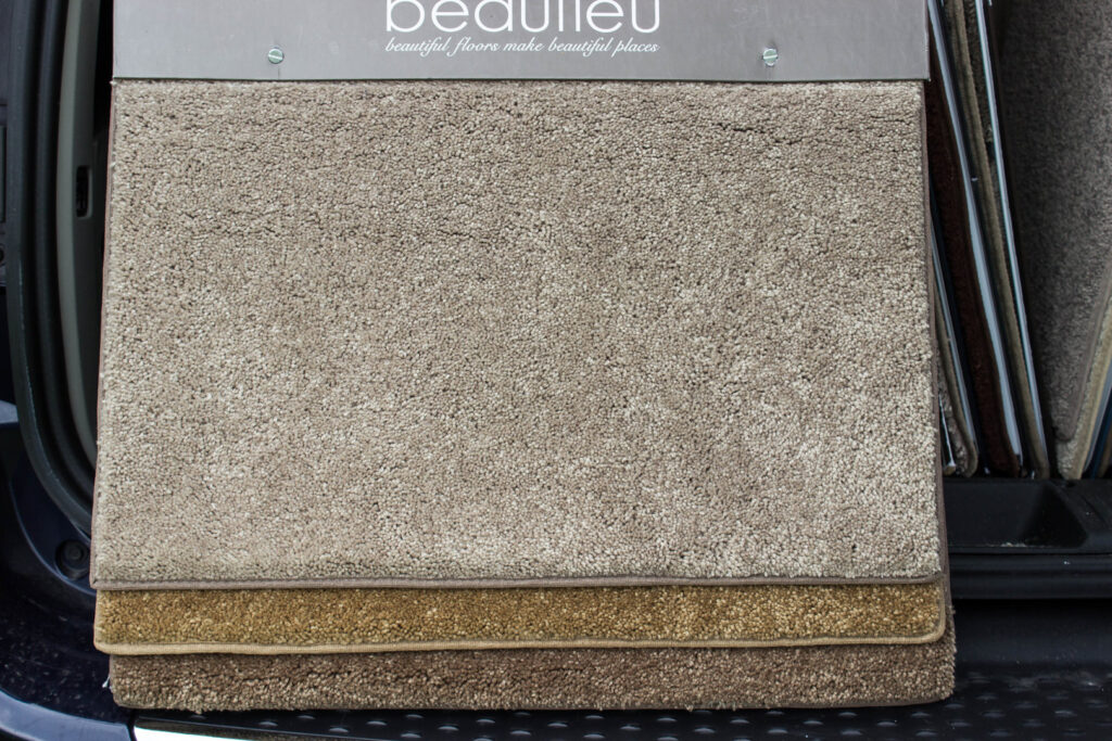 A large carpet sample board showcasing different textures and colors, offered by Home Based Carpet & Flooring in Cincinnati, OH.