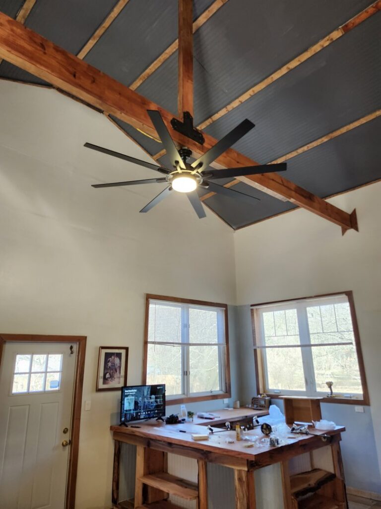 A large ceiling fan with a light installed in a room by ABS Electrical Services in Rogers, AR.