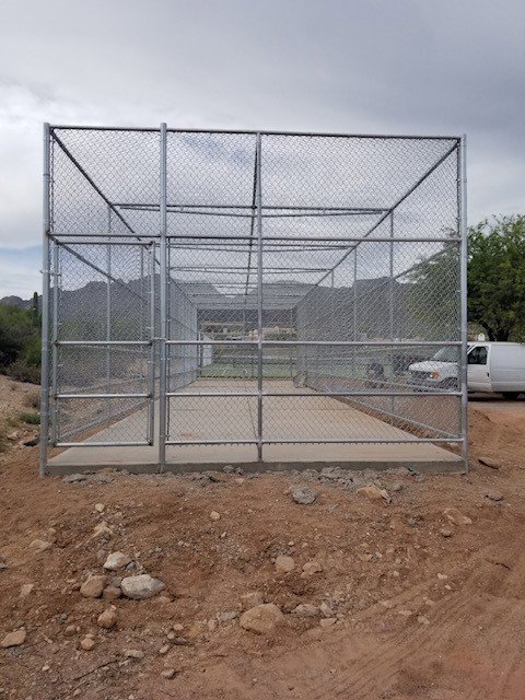 A large, custom-built chain-link enclosure or cage constructed by SFA Contracting LLC in Tucson, AZ.