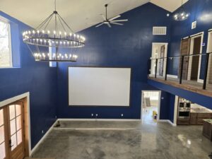 A large chandelier and ceiling fan installed in a spacious room, showcasing electrical fixture work by Warner Electric Service, LLC in Broken Arrow, OK.