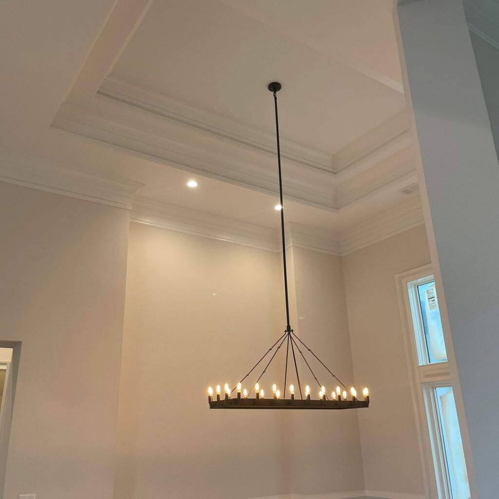 A grand chandelier expertly installed in a high-ceiling room by J&M Electrical Services in Stockbridge, GA.