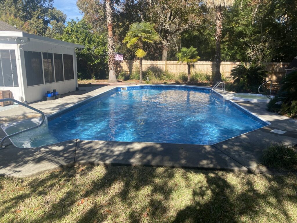 A large, clean blue swimming pool, sparkling after service from Pool King in Southhold, NY.