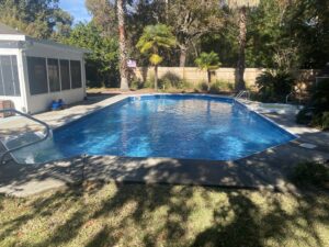 A large, clean blue swimming pool, sparkling after service from Pool King in Southhold, NY.