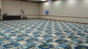 A large commercial room with a newly installed or cleaned patterned carpet by Chuy's Carpet Cleaning in Richland Hills, TX
