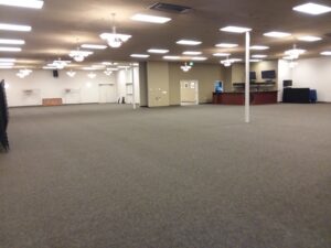 A spacious commercial room with clean grey carpet, serviced by JR Professional Carpet Cleaning Business LLC in Spokane, WA.