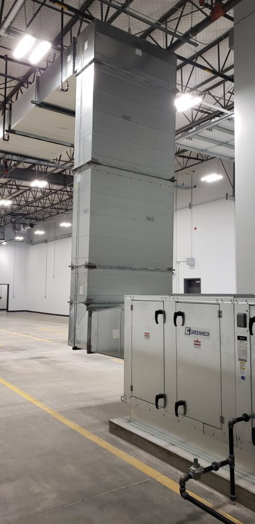 A large commercial HVAC air handler unit and extensive ductwork installed by HVAC Solutions in Colorado Springs, CO