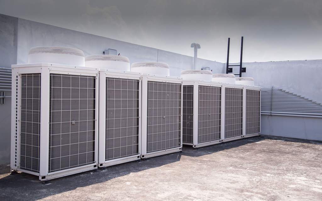 A row of large commercial HVAC systems installed on a rooftop by Service2.0 in Toledo, OH.