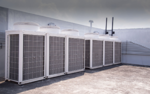 A row of large commercial HVAC systems installed on a rooftop by Service2.0 in Toledo, OH.