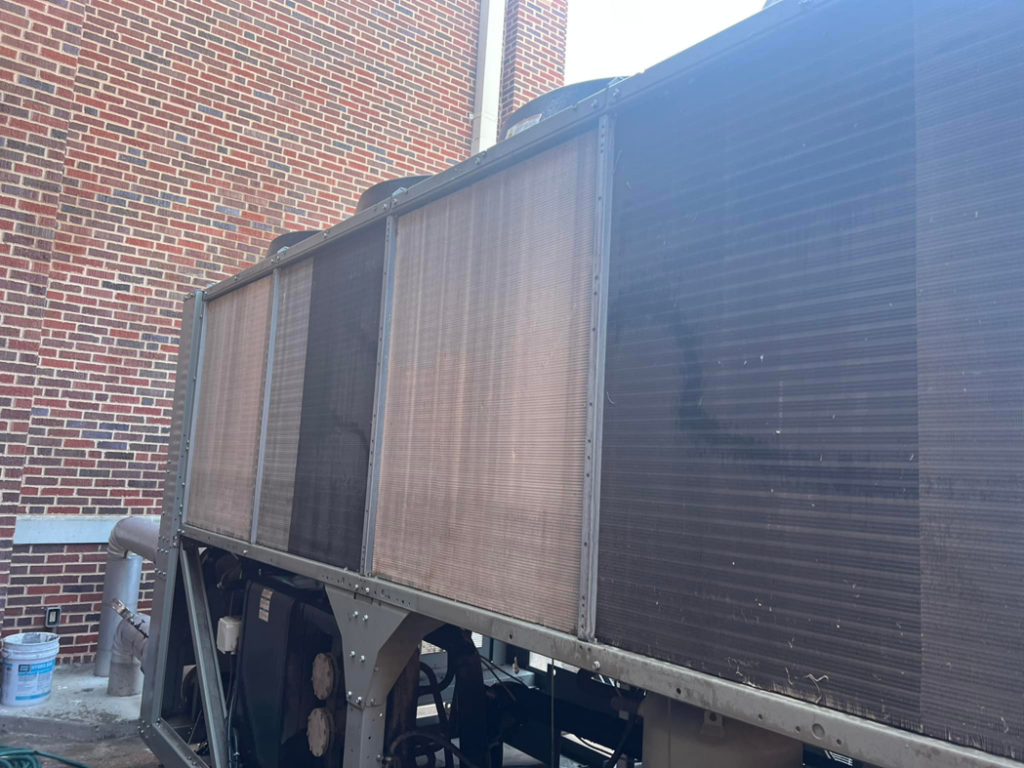 The exterior of a large commercial HVAC unit with visible coils, maintained by Evans Heat & Air in Ruther Glen, VA.